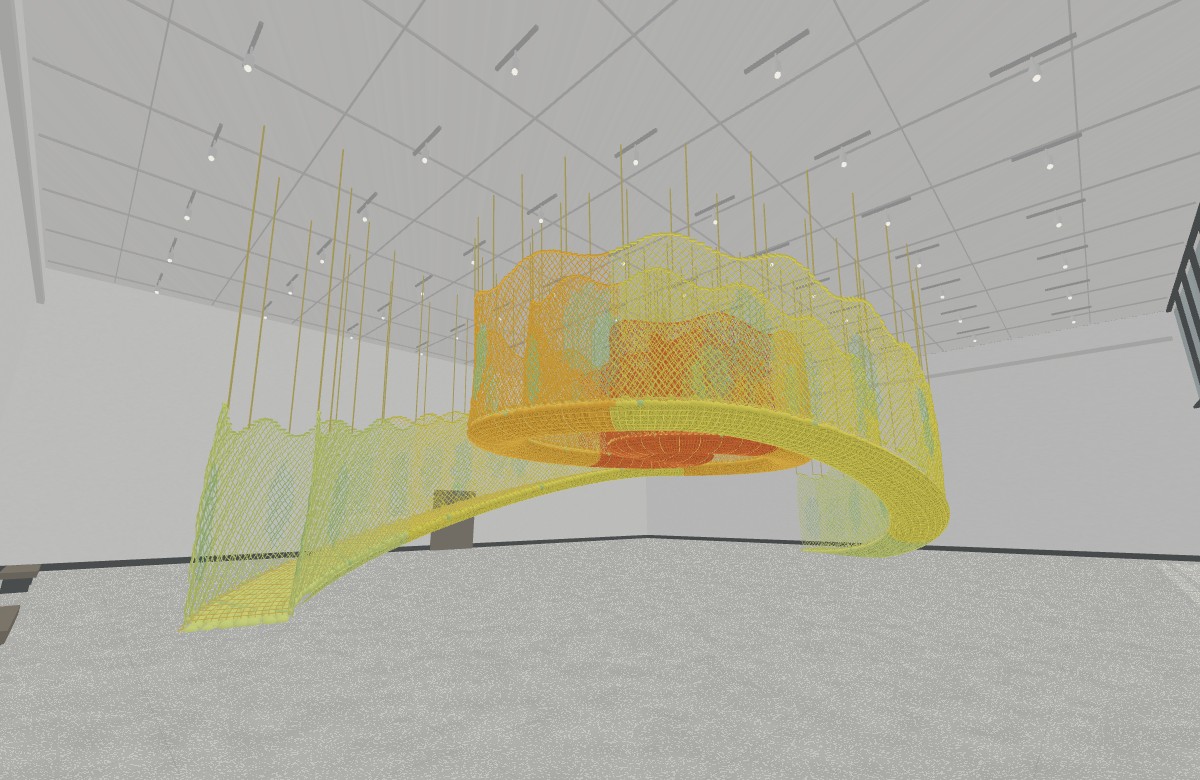 A suspended yellow, orange and green crochet spiral above the floor of Cullinan Hall